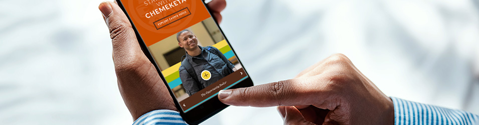 Close up of student holding a smartphone with the Chemeketa website displayed on the screen